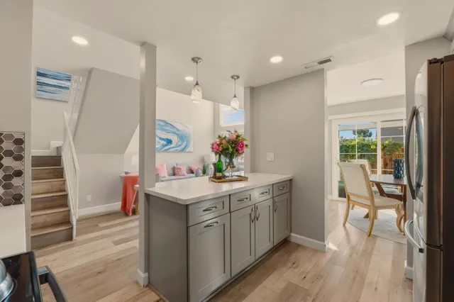 a kitchen with kitchen island white cabinets and white appliances