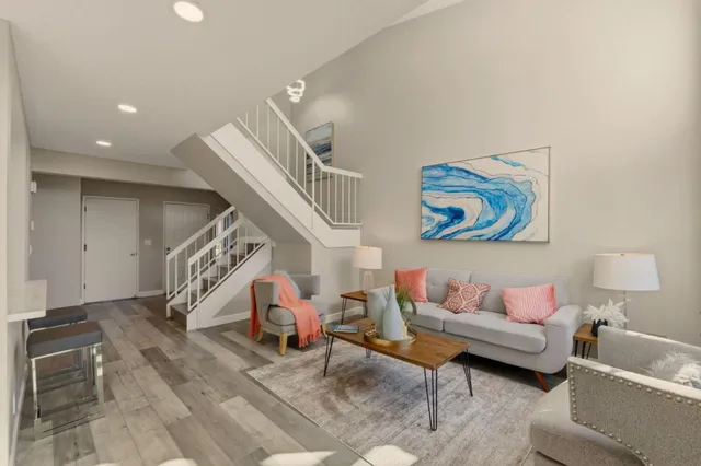 a living room with furniture and wooden floor