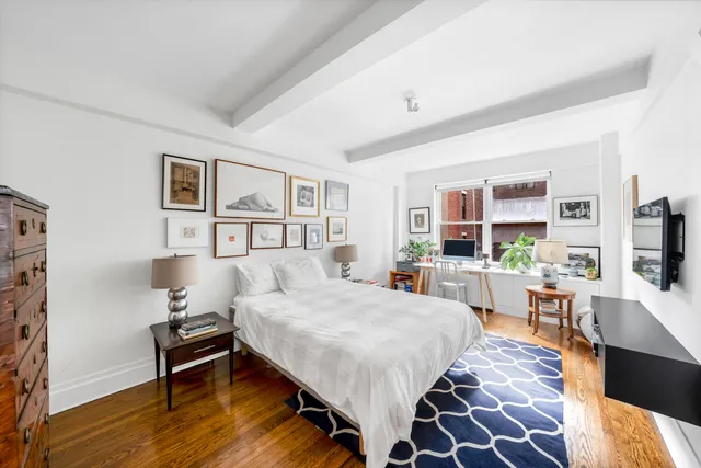 a workspace with wooden floor and furniture