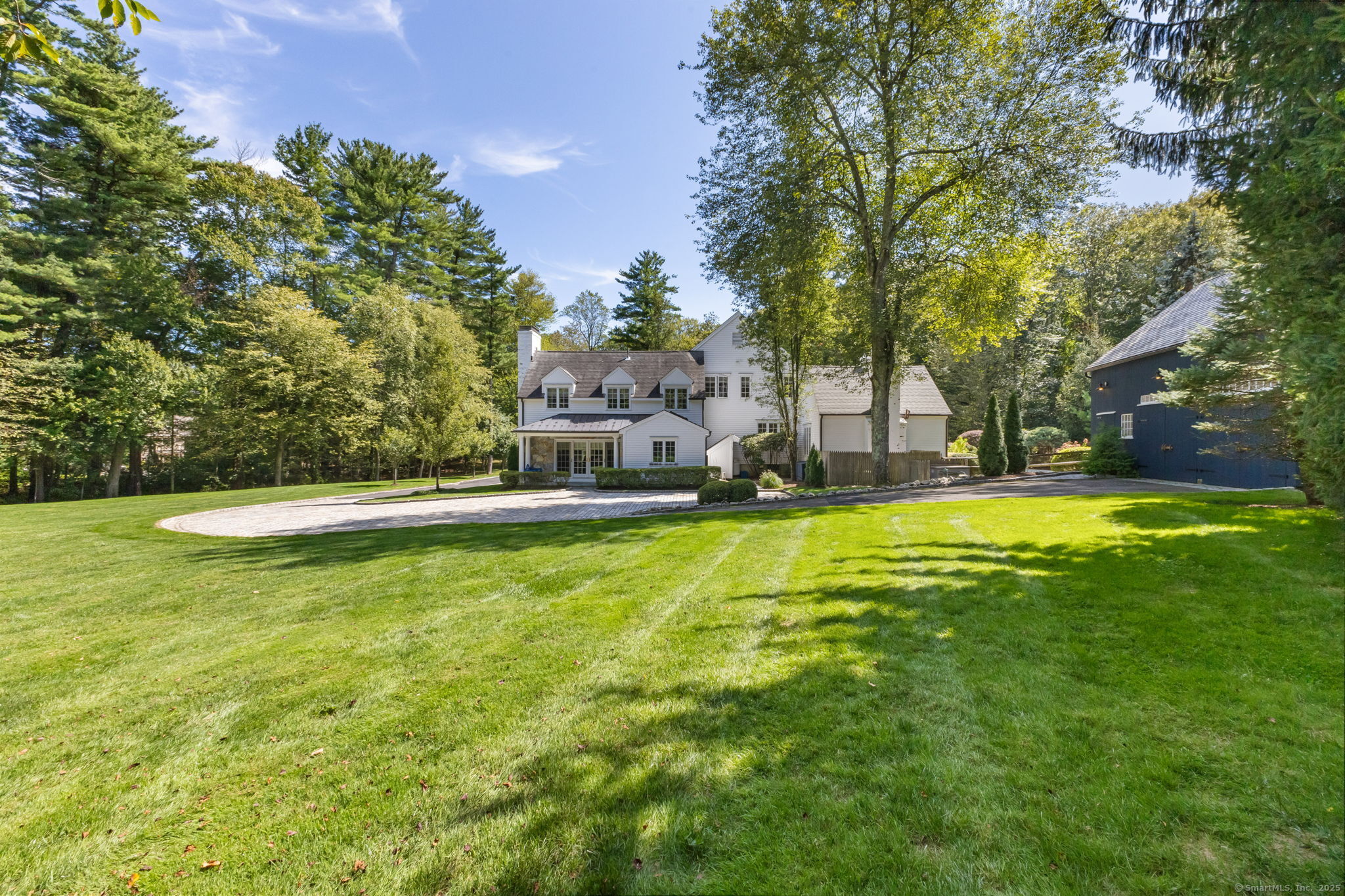 245 Benedict Hill Road New Canaan, CT 06840 - Photo 11 of 49 a view of a swimming pool with an outdoor space and seating area