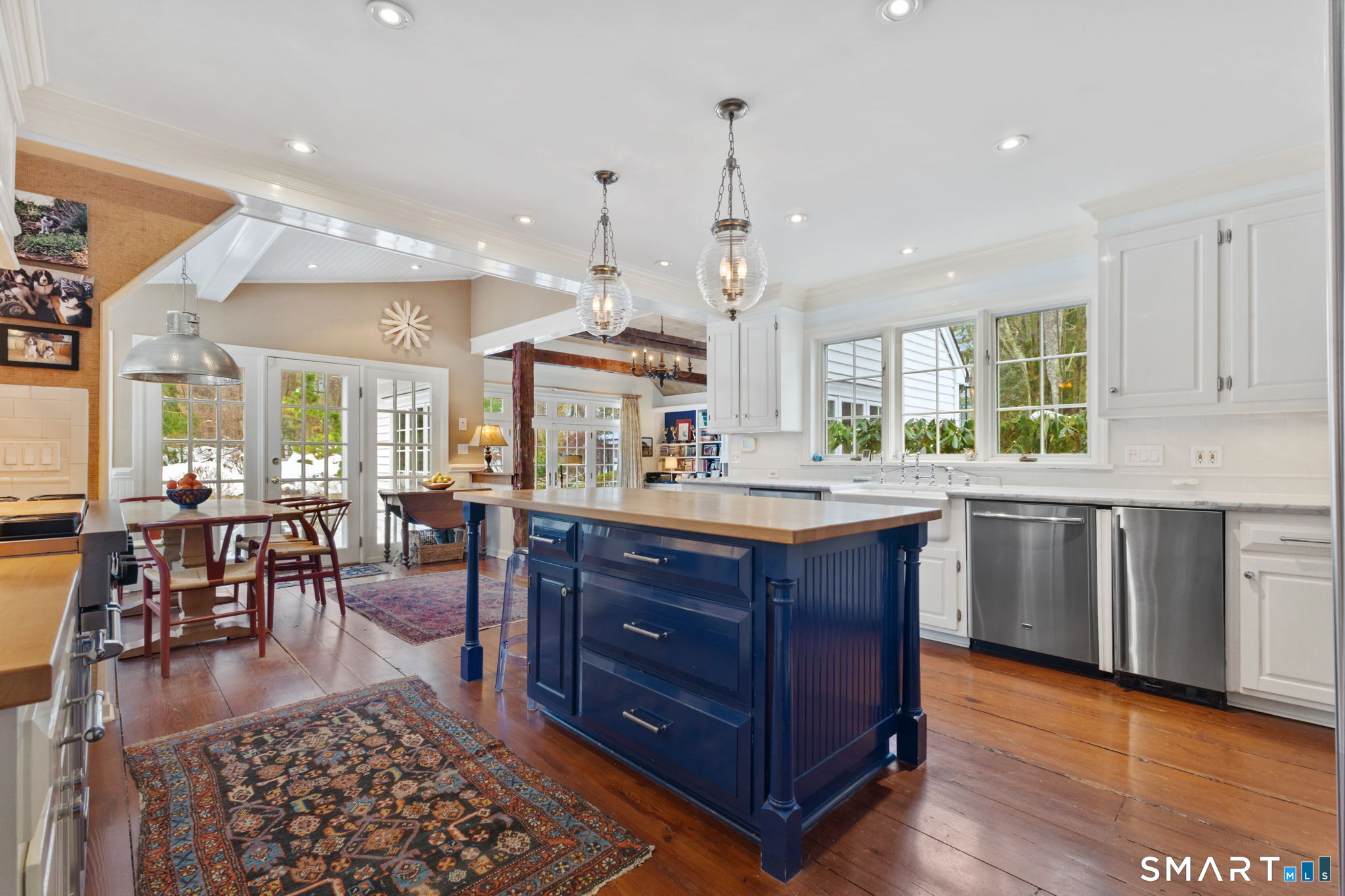 245 Benedict Hill Road New Canaan, CT 06840 - Photo 18 of 49 a kitchen with stainless steel appliances granite countertop a stove a sink a dining table wooden floor and kitchen view