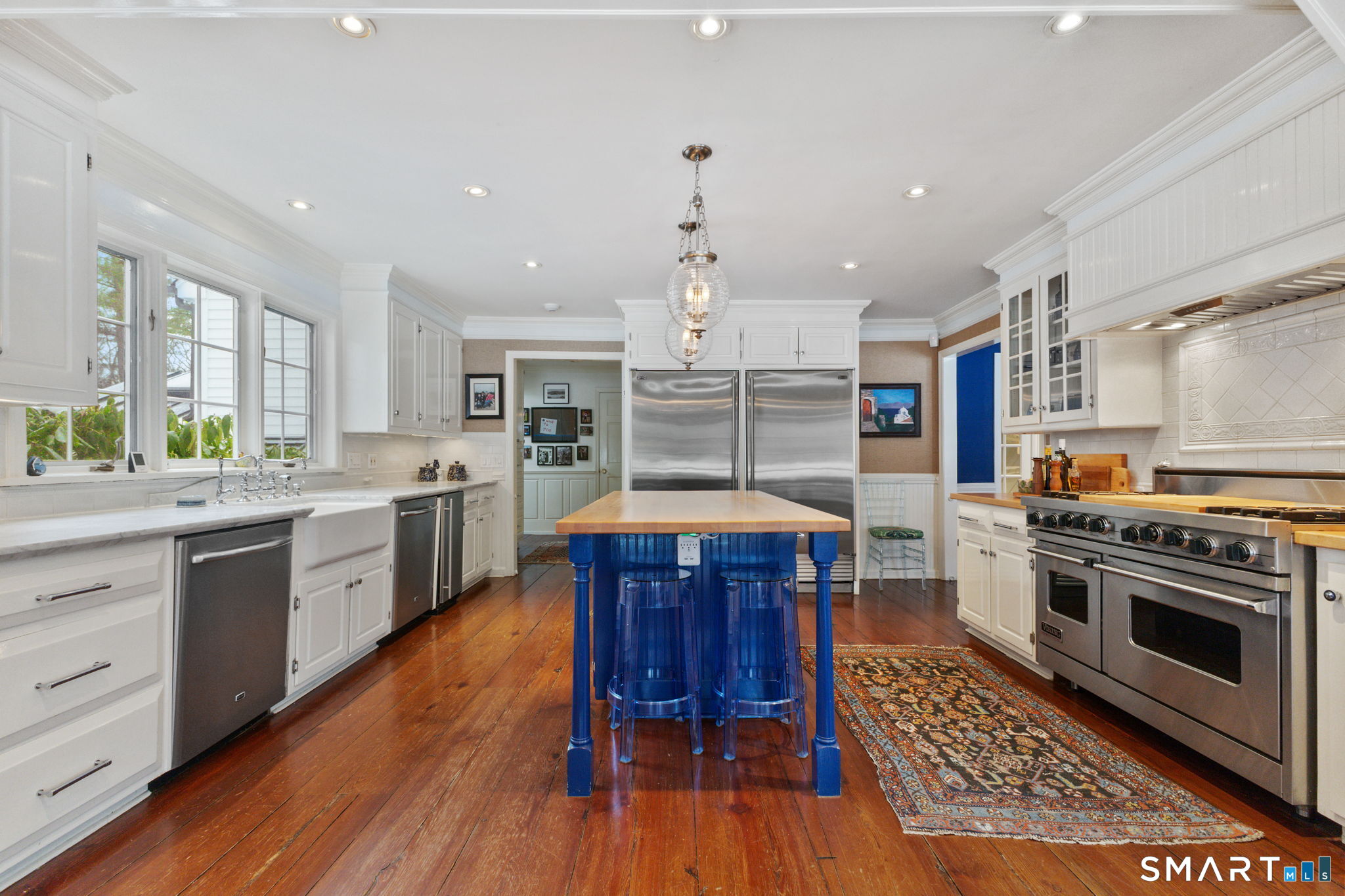 245 Benedict Hill Road New Canaan, CT 06840 - Photo 19 of 49 a kitchen with wooden floors wooden cabinets and appliances