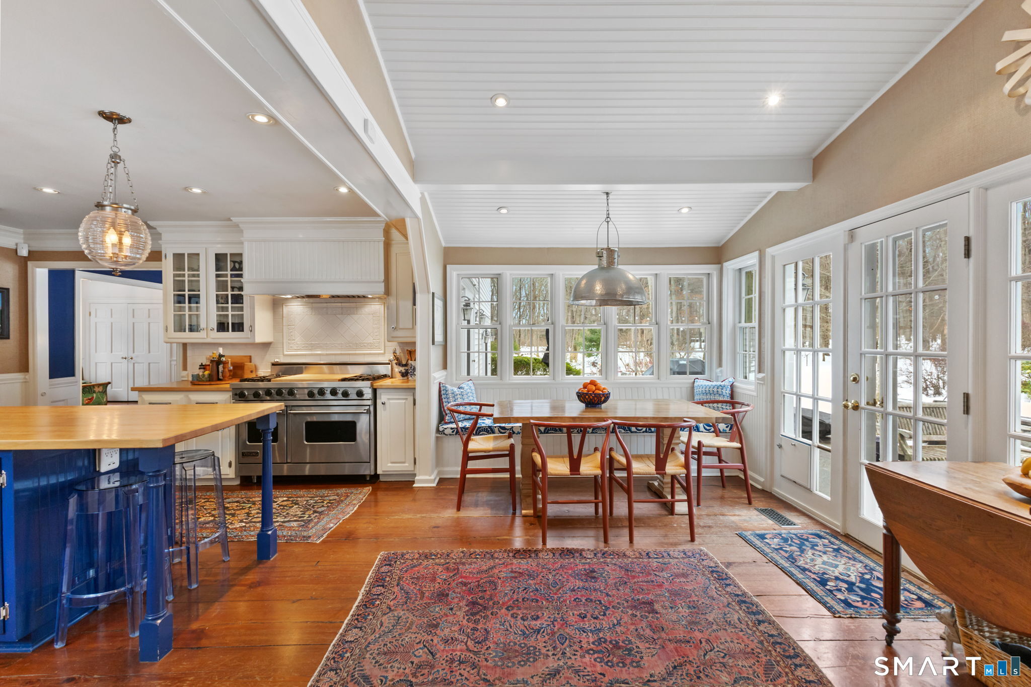 245 Benedict Hill Road New Canaan, CT 06840 - Photo 21 of 49 a large kitchen with a table and chairs in it