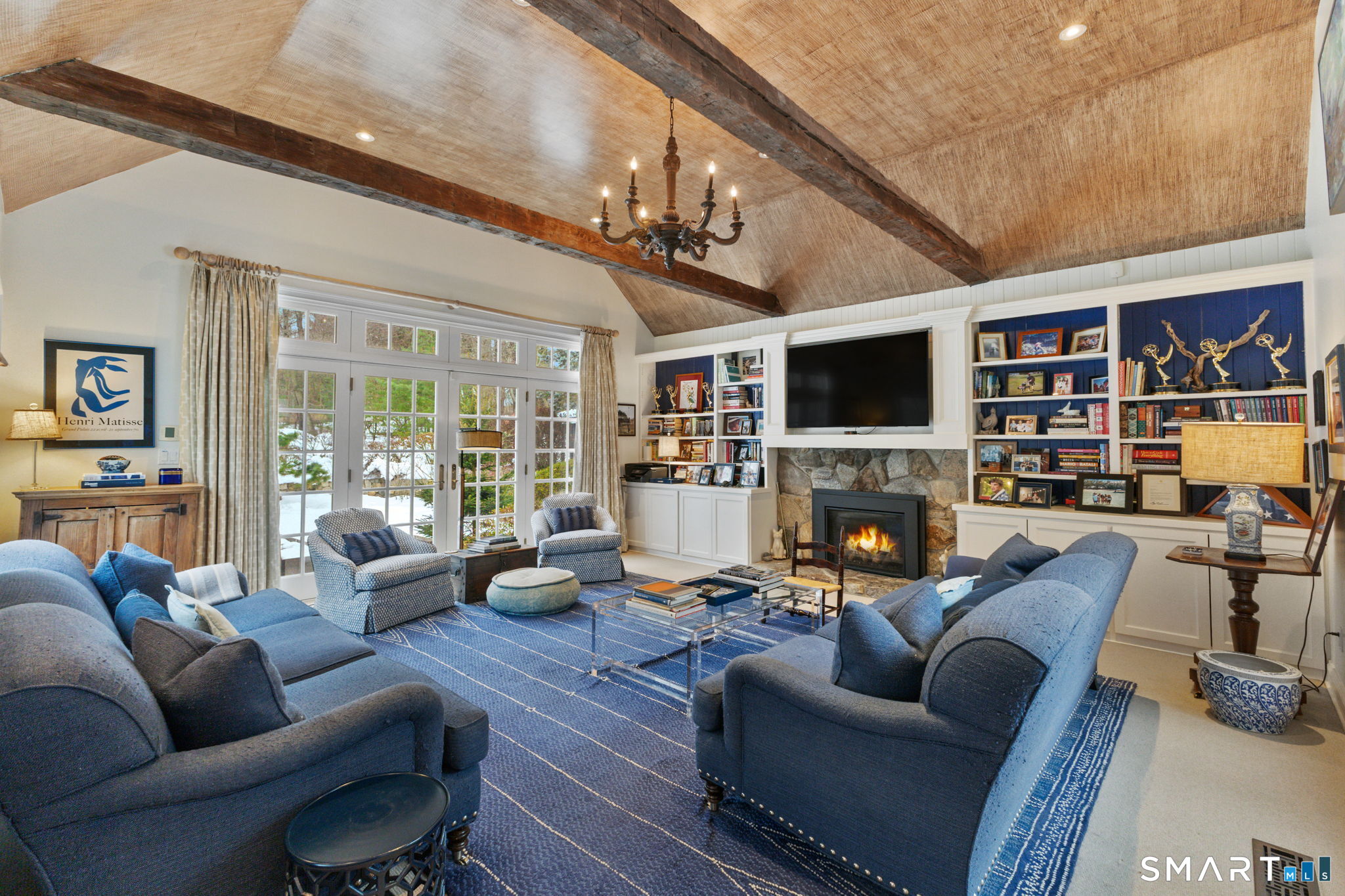 245 Benedict Hill Road New Canaan, CT 06840 - Photo 24 of 49 a living room with furniture a fireplace and a flat screen tv