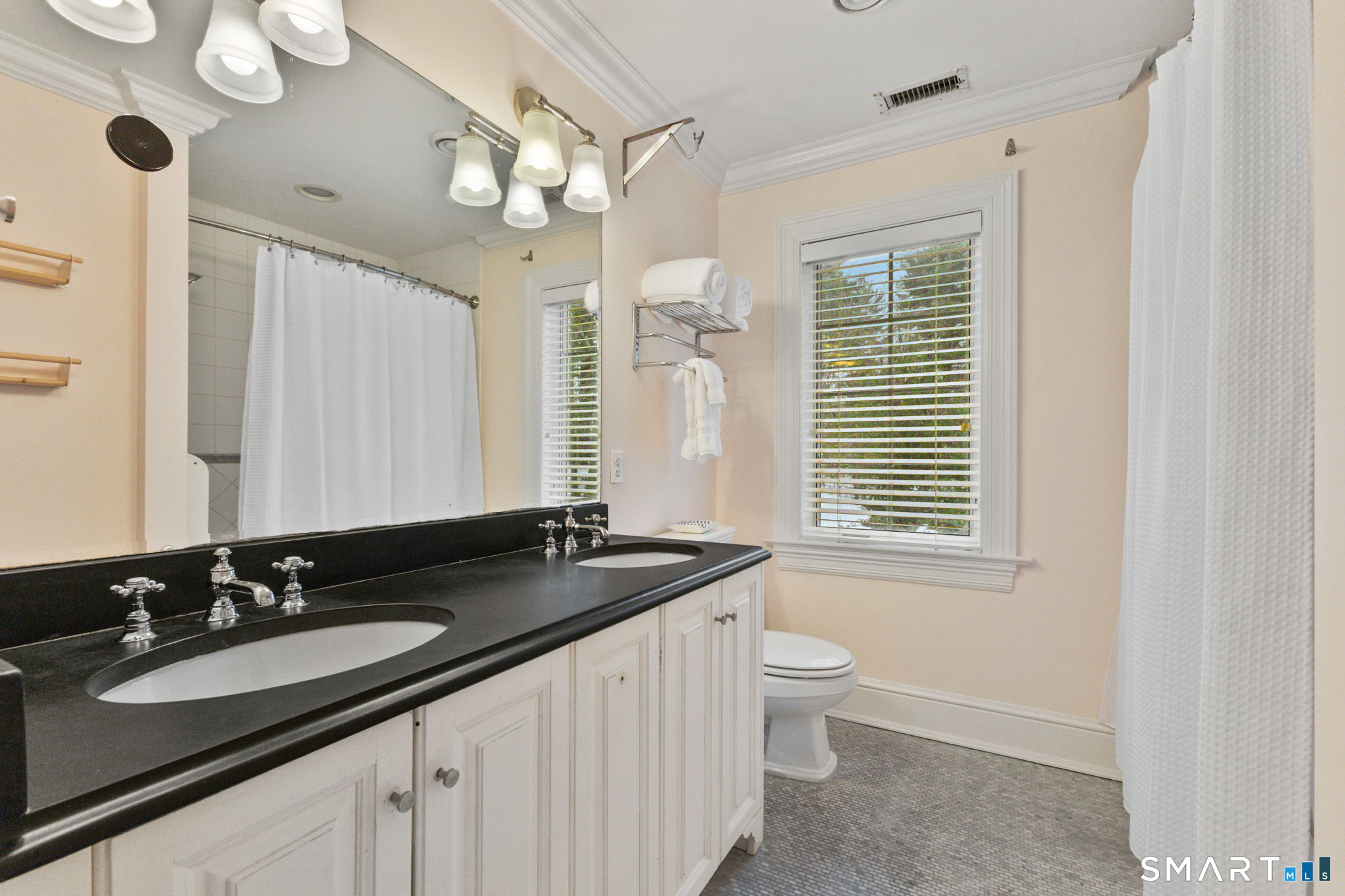 245 Benedict Hill Road New Canaan, CT 06840 - Photo 27 of 49 a bathroom with a granite countertop sink a large mirror a toilet and a window