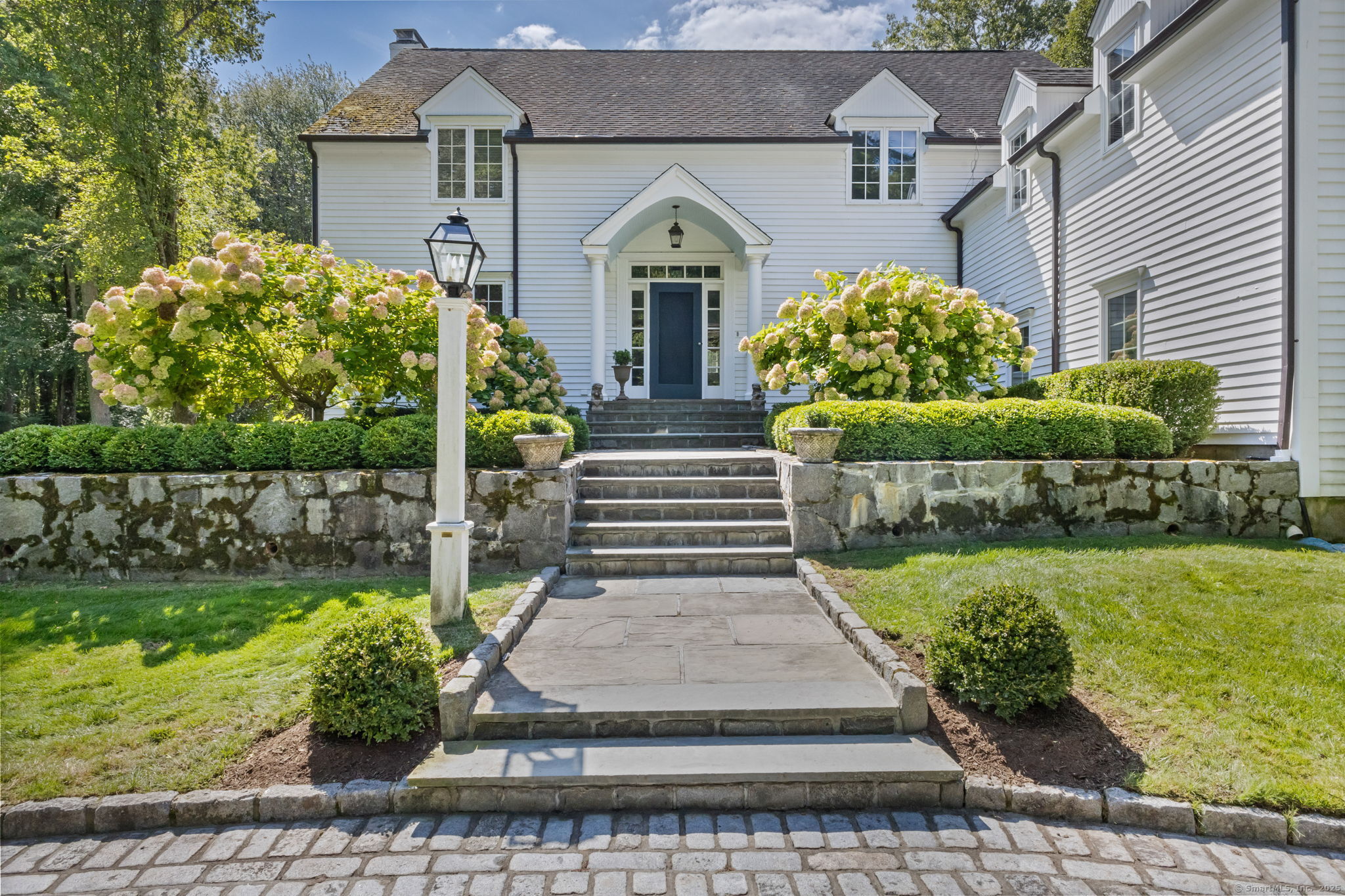 245 Benedict Hill Road New Canaan, CT 06840 - Photo 3 of 49 a front view of a house with a garden