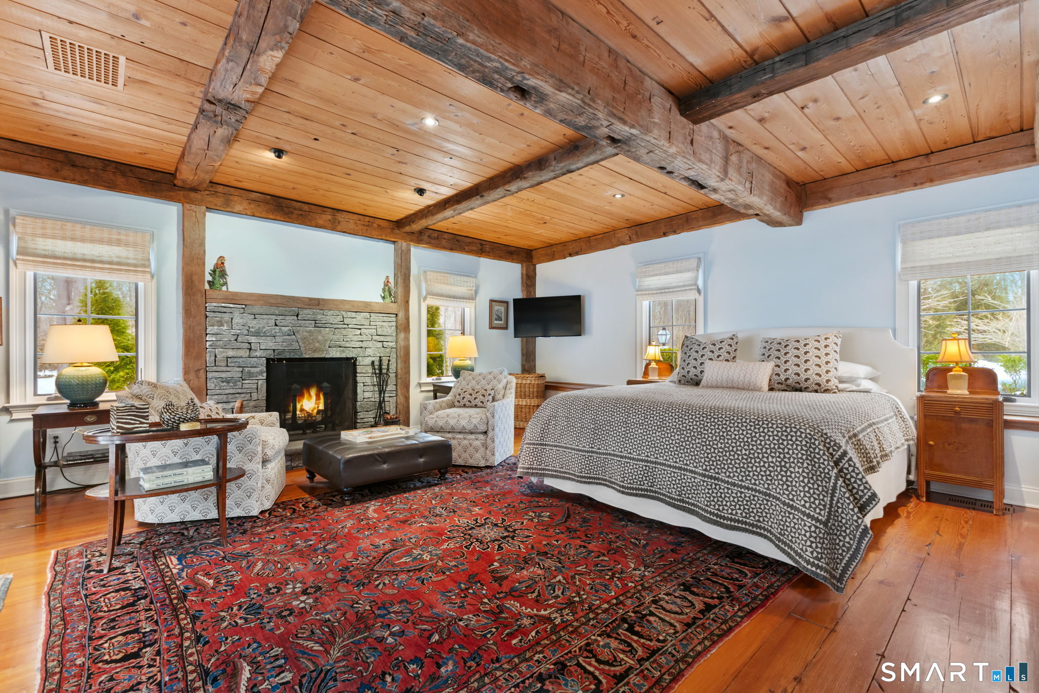 245 Benedict Hill Road New Canaan, CT 06840 - Photo 32 of 49 a bedroom with furniture and a fireplace