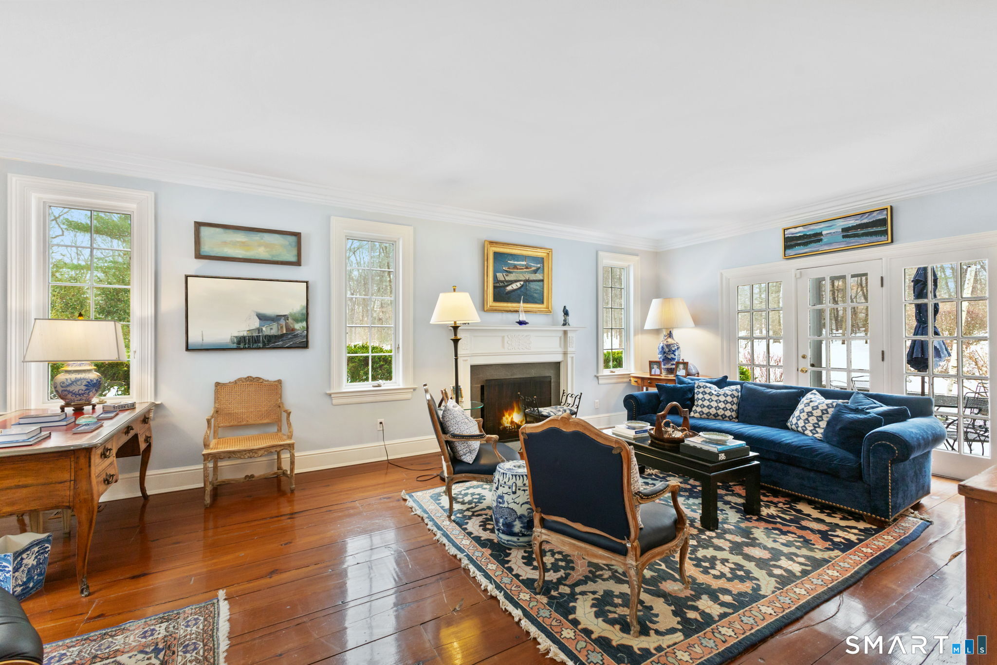 245 Benedict Hill Road New Canaan, CT 06840 - Photo 37 of 49 a living room with furniture a fireplace and a large window