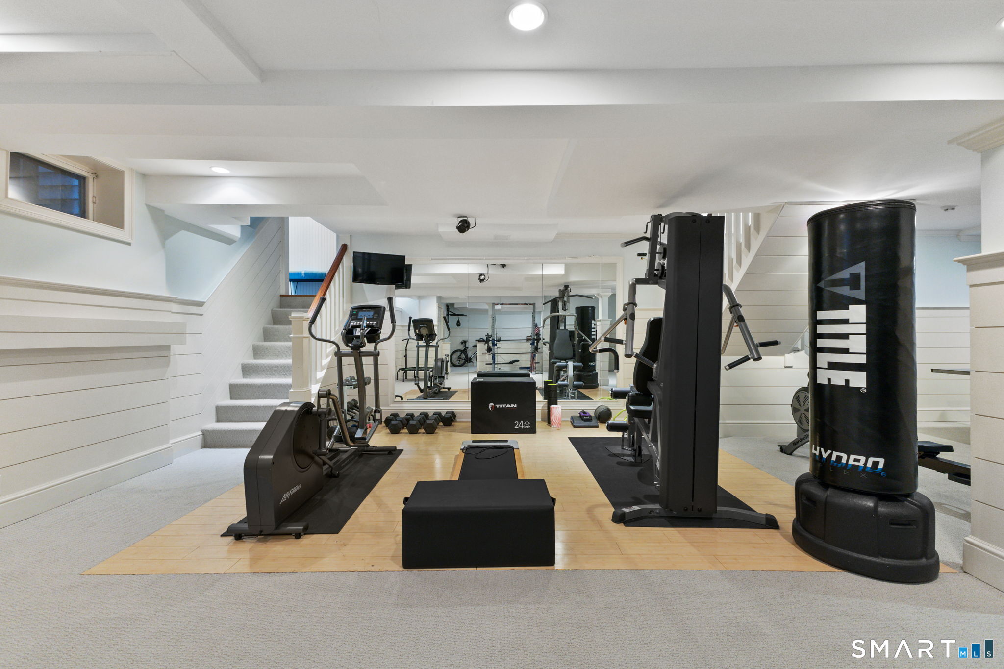 245 Benedict Hill Road New Canaan, CT 06840 - Photo 46 of 49 a living room with lots of furniture and gym equipment