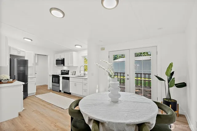 a view of a livingroom with wooden floor and a fireplace