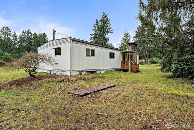 a backyard of a house with table and chairs