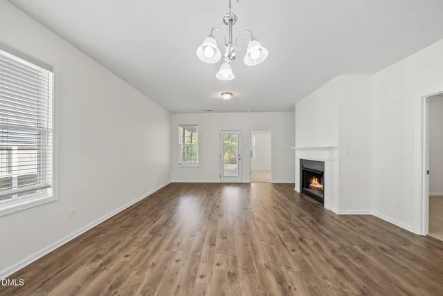 a view of an empty room with a fireplace