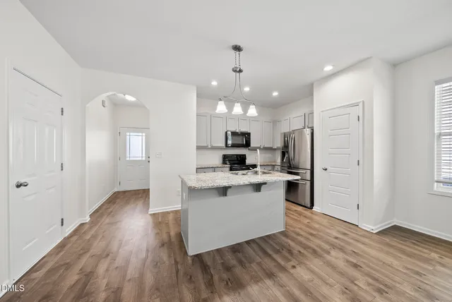 a view of kitchen with livingroom and fireplace
