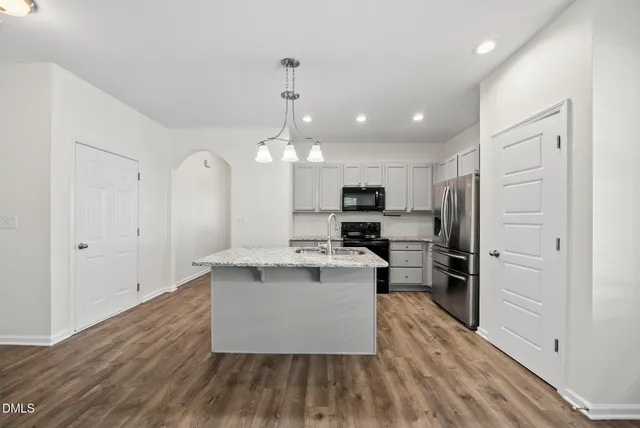 a view of kitchen with sink microwave and stove