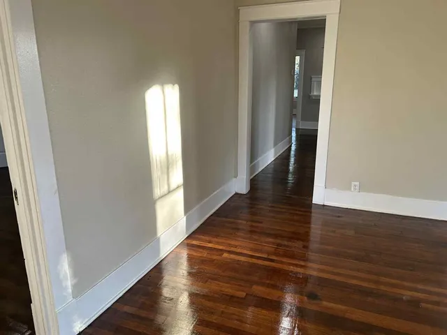 a view of a hallway with wooden floor