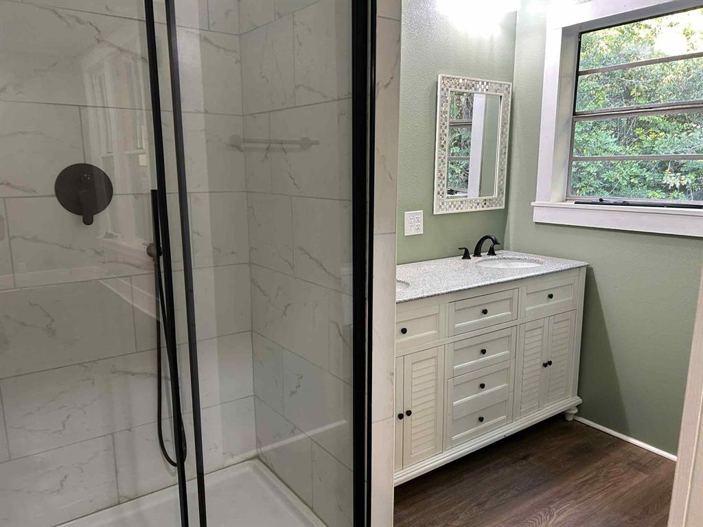 321 Kings Highway Mansfield, LA 71052 - Photo 17 of 22 a bathroom with a double vanity sink a mirror and a shower