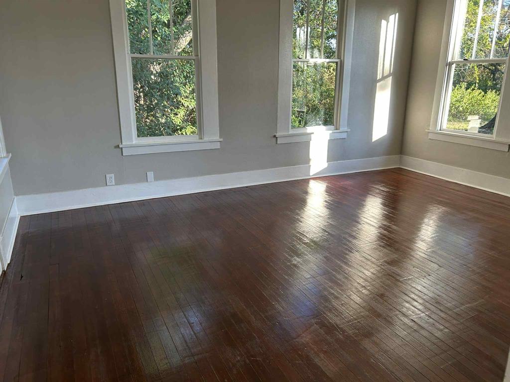 321 Kings Highway Mansfield, LA 71052 - Photo 19 of 22 an empty room with wooden floor and windows