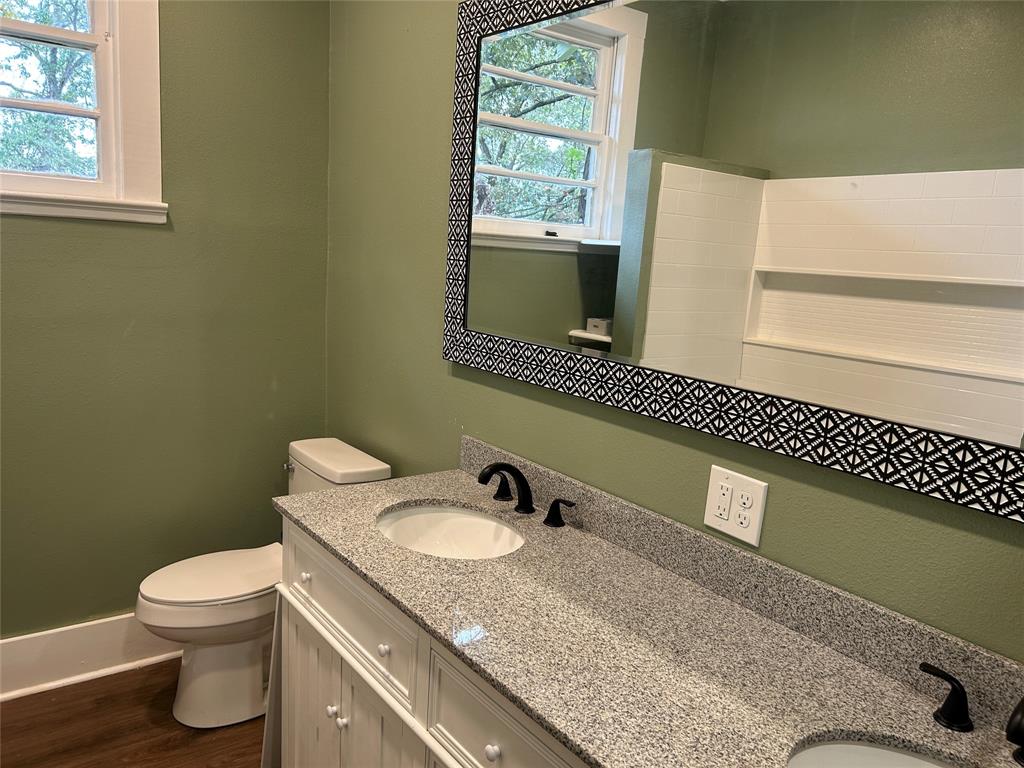 321 Kings Highway Mansfield, LA 71052 - Photo 21 of 22 a bathroom with a granite countertop sink toilet and mirror
