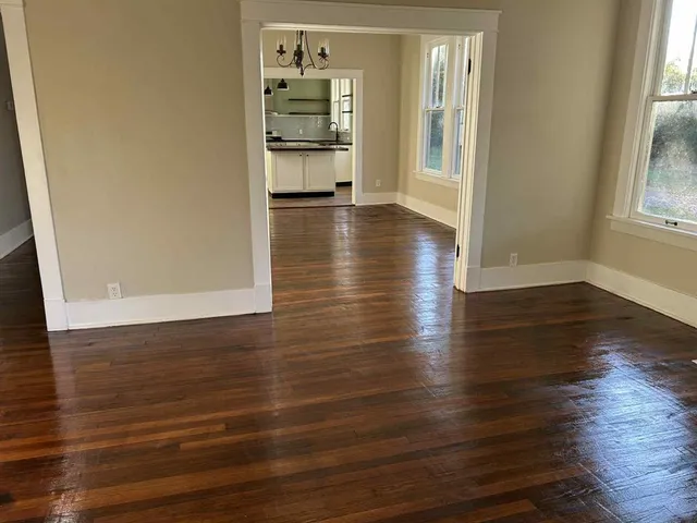 wooden floor in an empty room with a window