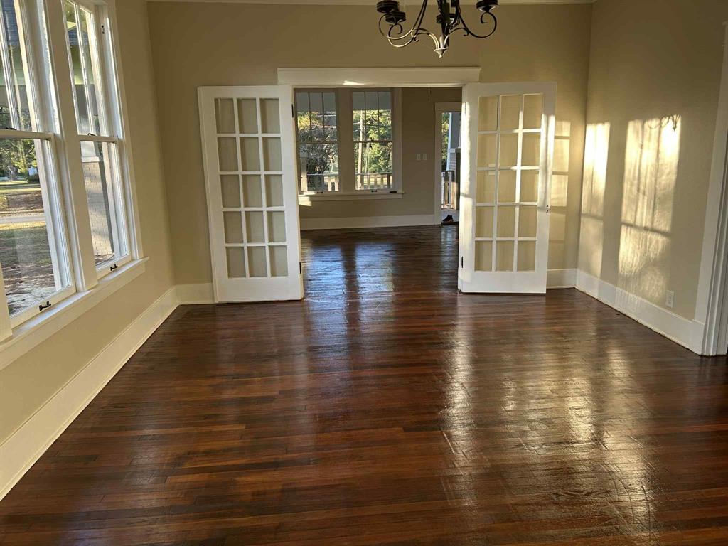 321 Kings Highway Mansfield, LA 71052 - Photo 10 of 22 a view of an empty room with wooden floor and a window