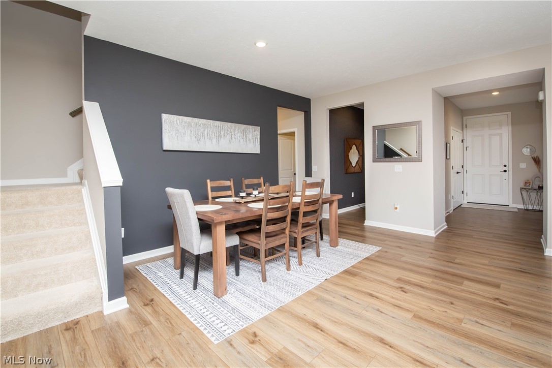 Dining space featuring light wood finished floors and recessed lighting