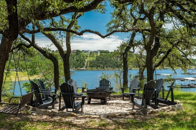 a view of a park with bench and a large tree