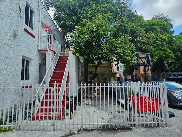 a view of a house with brick wall and potted plants
