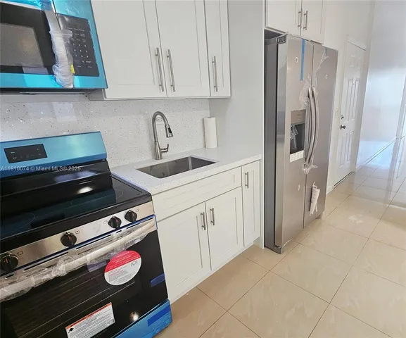 a kitchen with appliances and cabinets