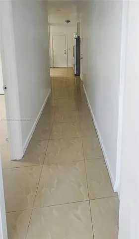 a view of hallway with a rug