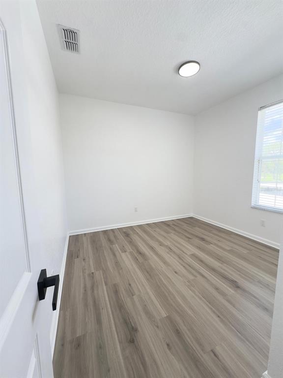 13512 Turtle Marsh Loop, Unit 729 Orlando, FL 32837 - Photo 13 of 42 a view of a room with wooden floor and white walls