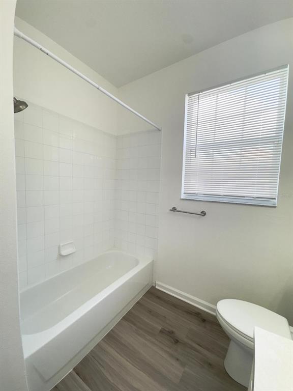 13512 Turtle Marsh Loop, Unit 729 Orlando, FL 32837 - Photo 16 of 42 a white toilet sitting next to a bath tub