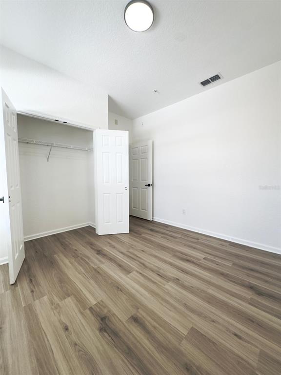 13512 Turtle Marsh Loop, Unit 729 Orlando, FL 32837 - Photo 17 of 42 a view of an empty room with wooden floor