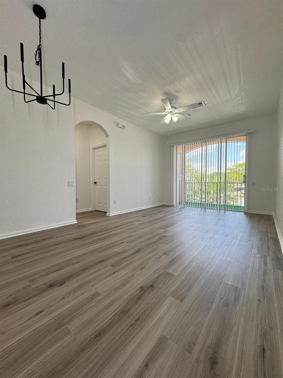 13512 Turtle Marsh Loop, Unit 729 Orlando, FL 32837 - Photo 21 of 42 a view of an empty room with wooden floor and a window