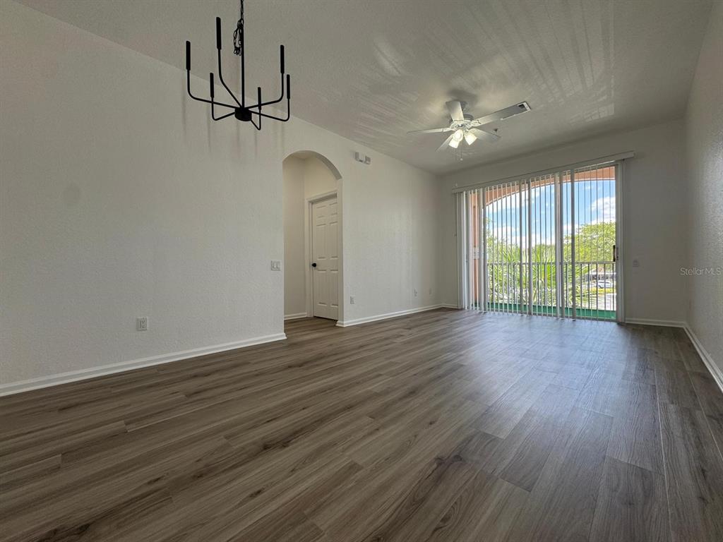 13512 Turtle Marsh Loop, Unit 729 Orlando, FL 32837 - Photo 22 of 42 a view of empty room with wooden floor and fan
