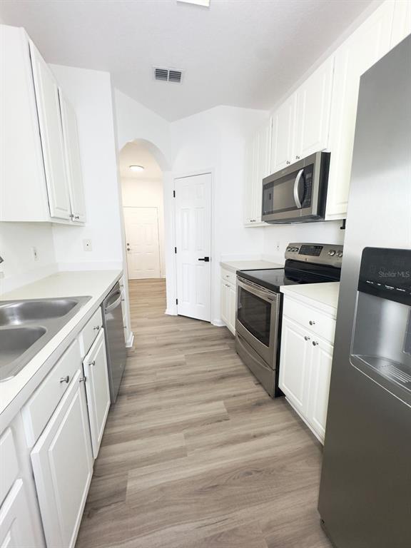 13512 Turtle Marsh Loop, Unit 729 Orlando, FL 32837 - Photo 39 of 42 a kitchen with stainless steel appliances a stove microwave and sink