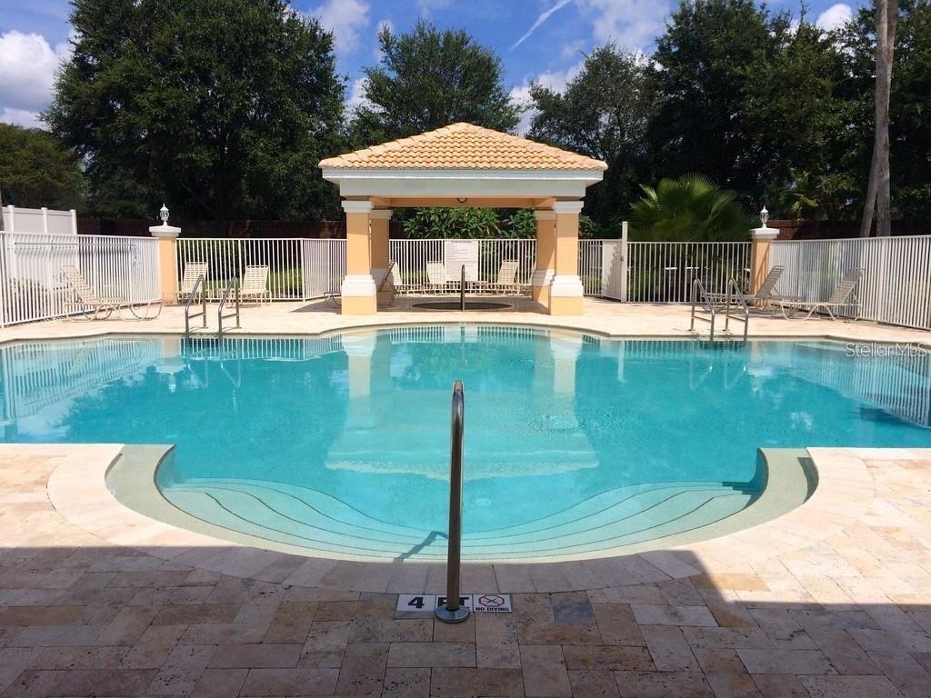 13512 Turtle Marsh Loop, Unit 729 Orlando, FL 32837 - Photo 6 of 42 a view of a swimming pool with a patio