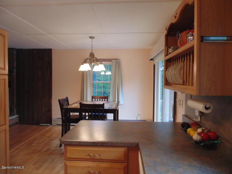 13 August Smith Road Peru, MA 01235 - Photo 5 of 20 a view of dining room and livingroom with furniture wooden floor windows and a chandelier