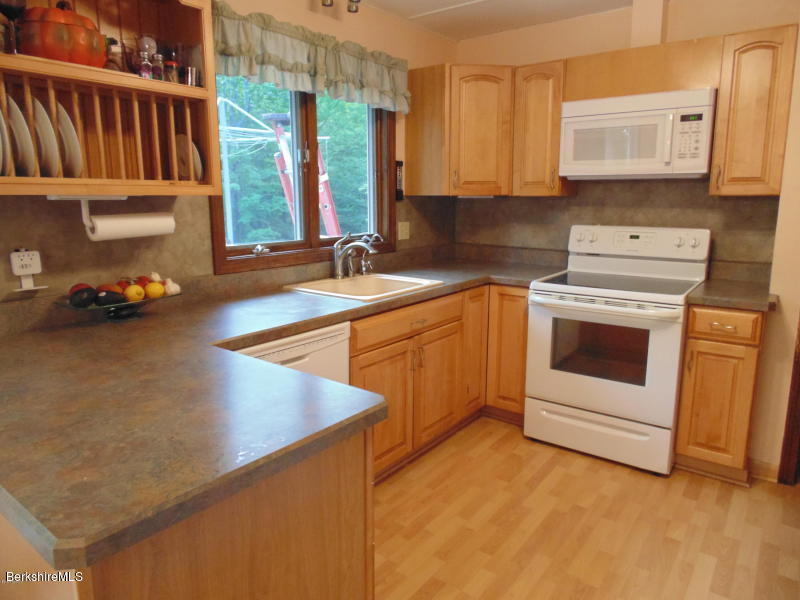 13 August Smith Road Peru, MA 01235 - Photo 6 of 20 a kitchen with a sink stove and cabinets