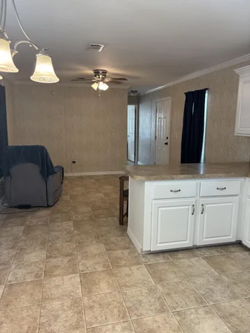a view of cabinets with granite countertop natural light