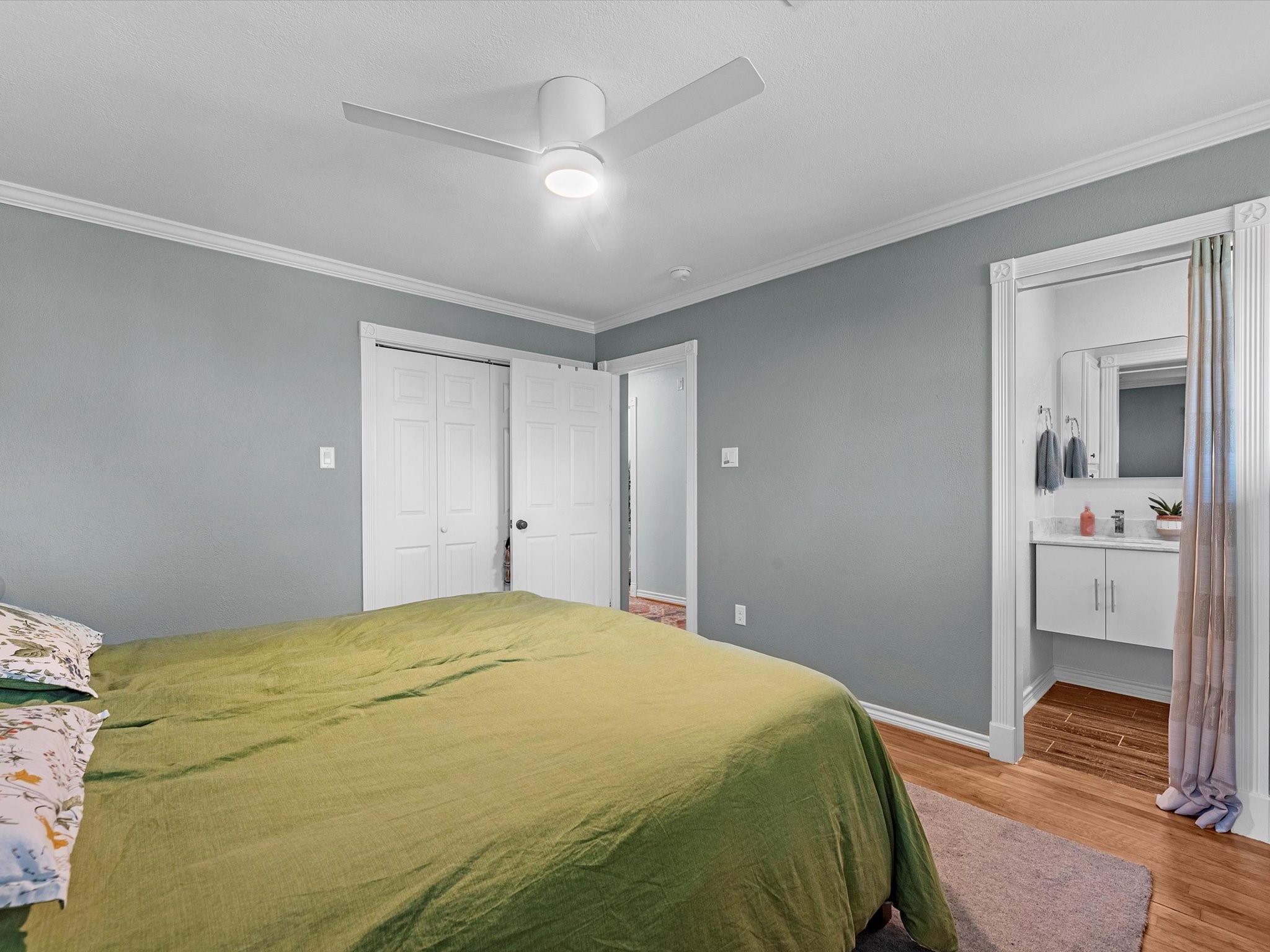 712 Barbara Street Tomball, TX 77375 - Photo 16 of 25 a bedroom with a bed and wooden floor