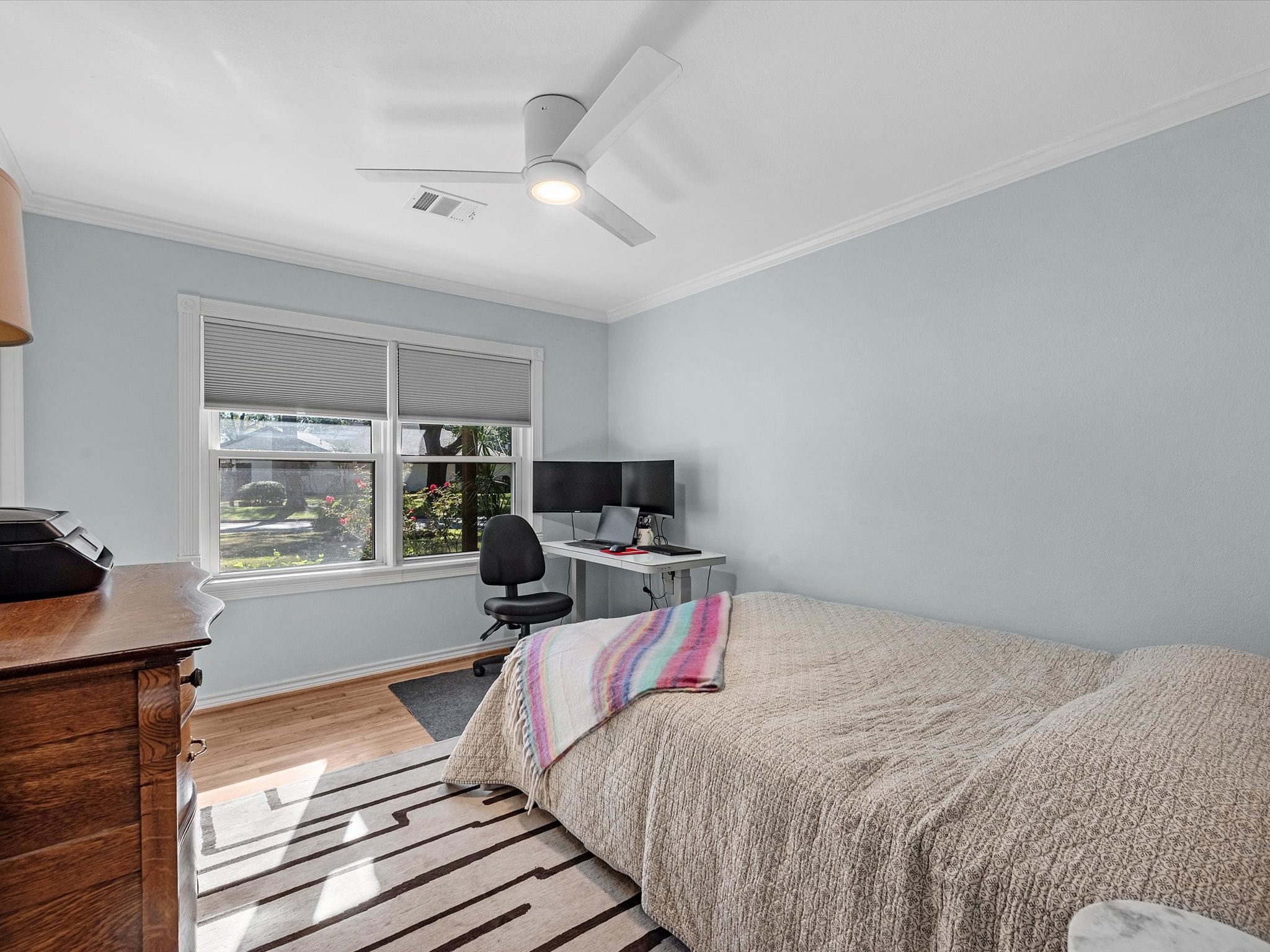 712 Barbara Street Tomball, TX 77375 - Photo 18 of 25 a bedroom with a bed and wooden floor
