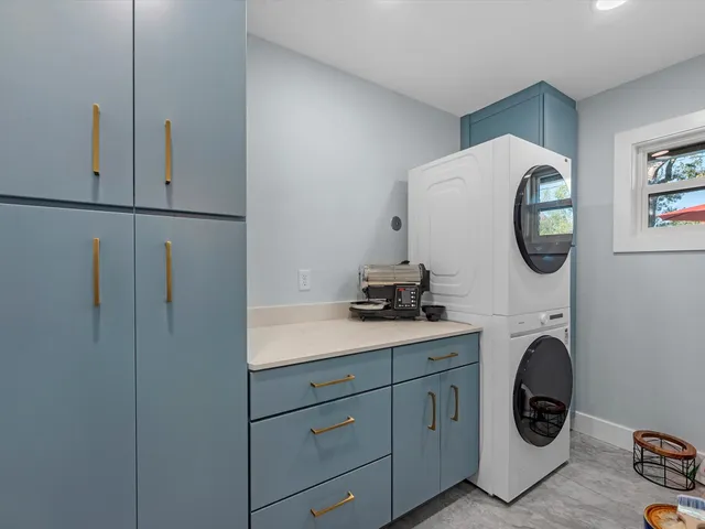 a utility room with sink dryer and washer