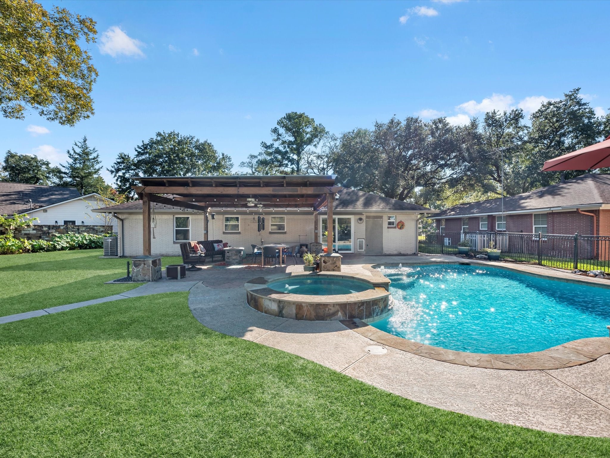712 Barbara Street Tomball, TX 77375 - Photo 22 of 25 a view of a house with backyard sitting area and garden