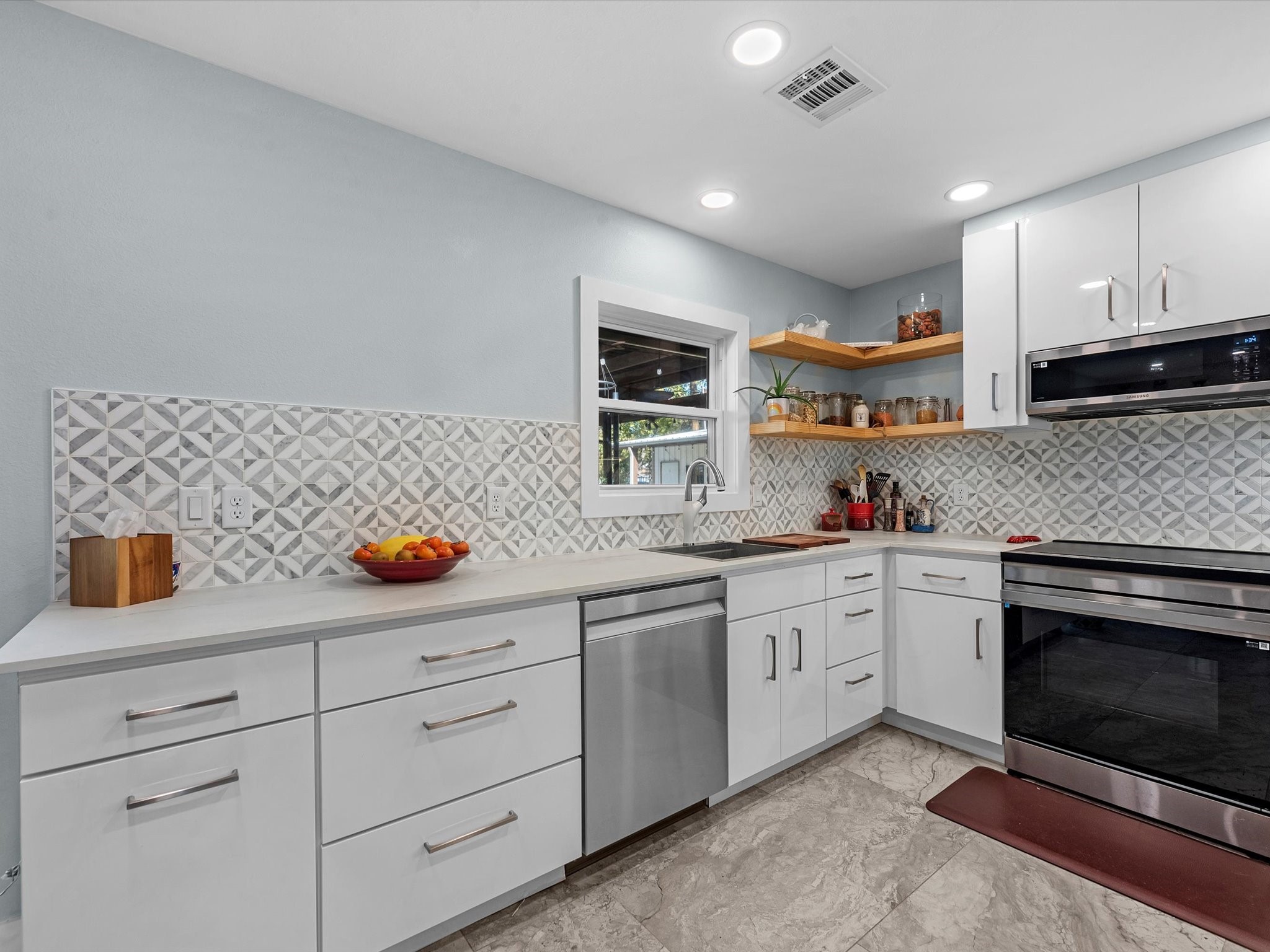 712 Barbara Street Tomball, TX 77375 - Photo 6 of 25 a kitchen with sink a stove and cabinets