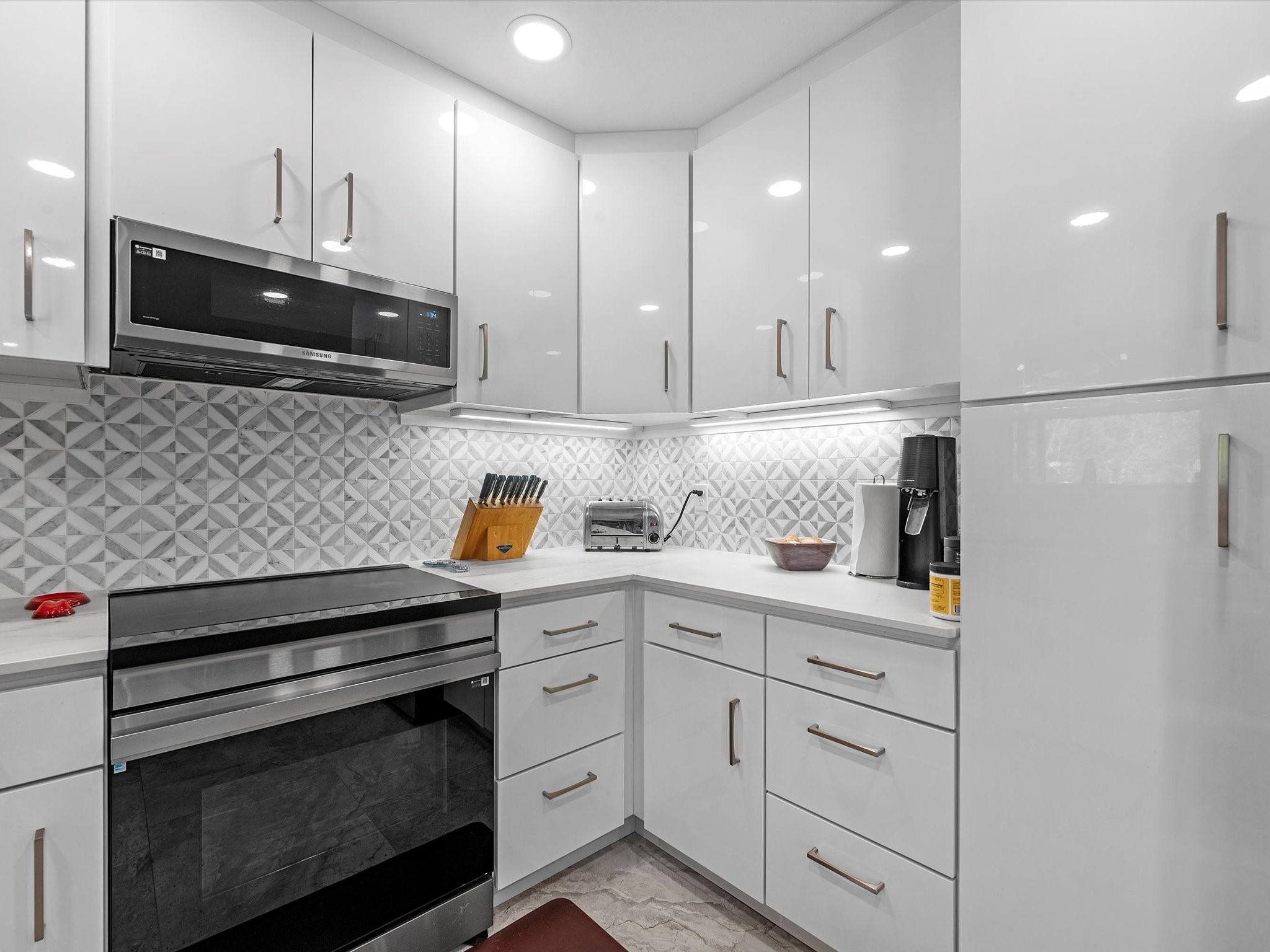 712 Barbara Street Tomball, TX 77375 - Photo 8 of 25 a kitchen with stainless steel appliances granite countertop a sink and a stove