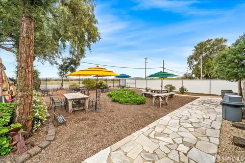 a view of a patio with table and chairs and potted plants