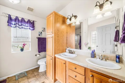 a kitchen with stainless steel appliances a stove a refrigerator a sink dishwasher with a dining table and chairs with wooden floor