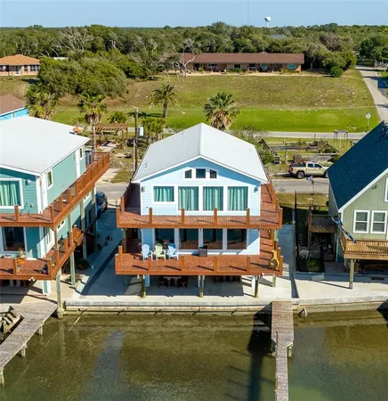 a small pool with lawn chairs and a table