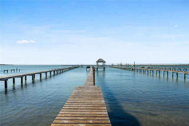 a view of a lake with a table and chairs