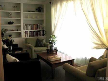 414 Tinkerbell Road Chapel Hill, NC 27517 - Photo 2 of 12 Elegant living room lends itself to conversation in front of the massive bay window and built-in bookshelves.
